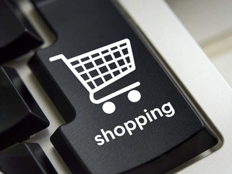 a black computer keyboard key with a shopping cart graphic on it