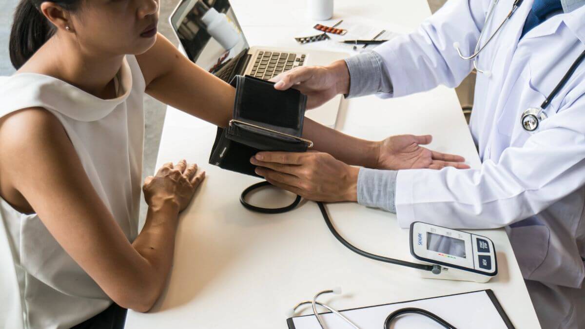 a doctor measuring blood pressure of a patient