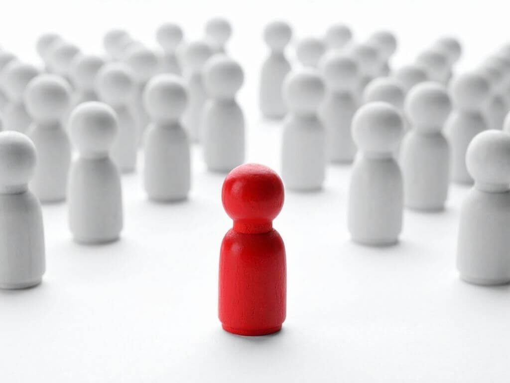 a red figure standing out from the rest